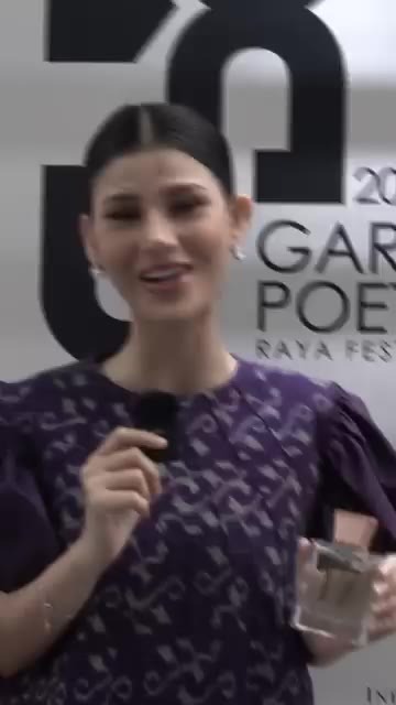 Miss Grand Indonesia 2023 with a House of Arwuda perfume bottle, reel cover